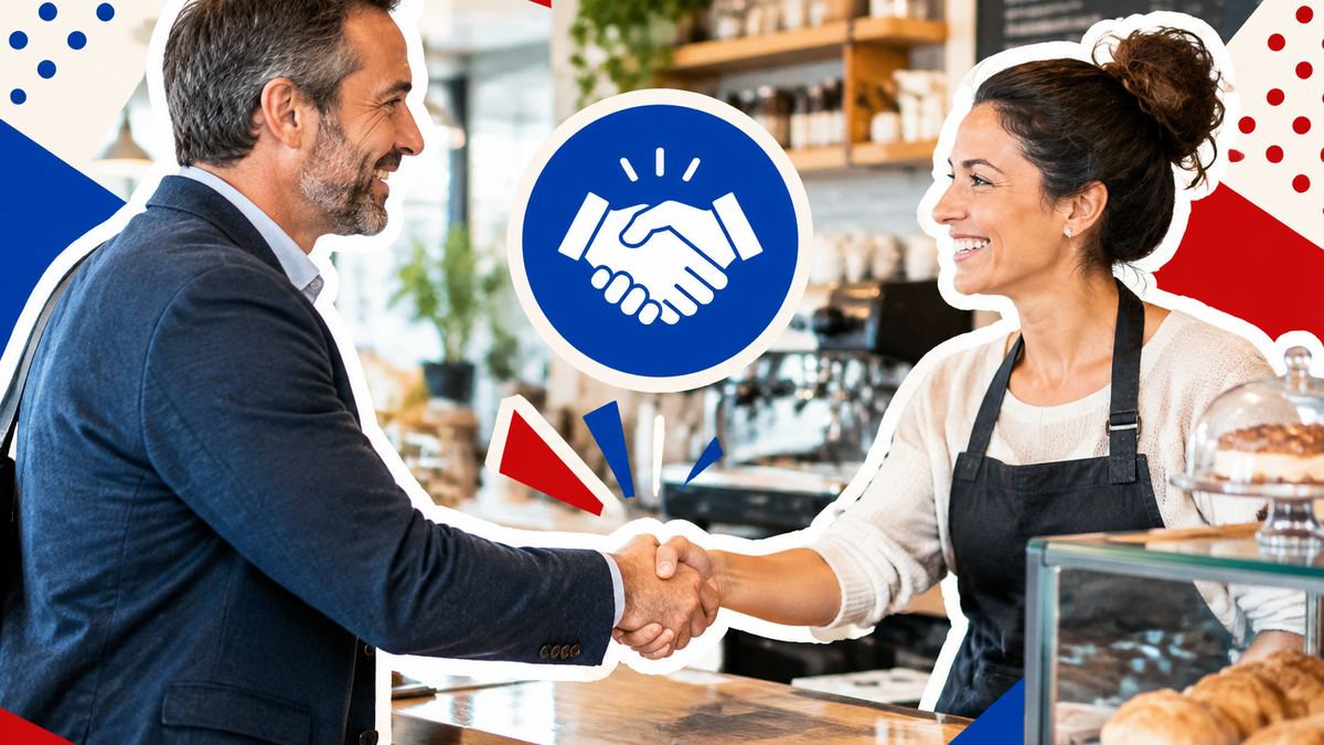 An organiser shaking hands with a café manager behind the counter