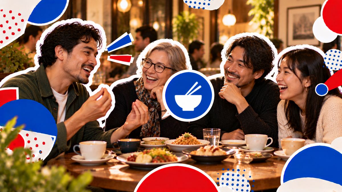 A small group at a café table laughing as one person describes a dish from their country