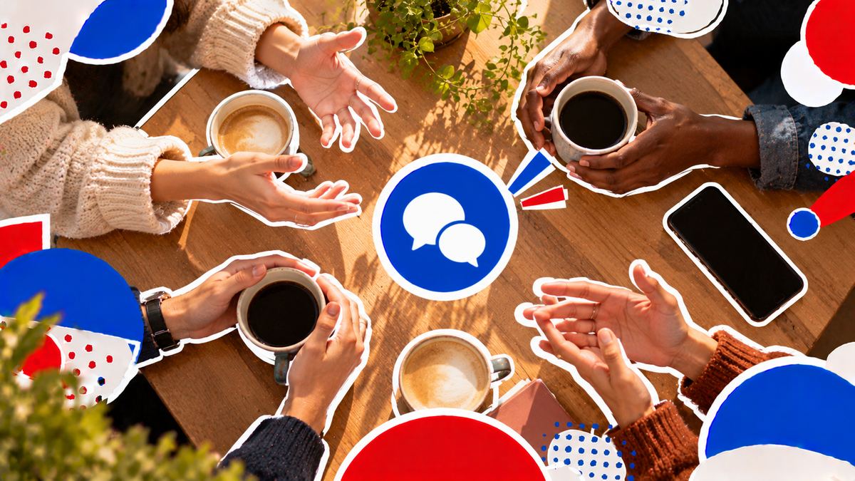 Hands around coffee cups on a café table, mid-conversation, seen from above